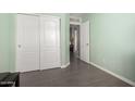 Bedroom featuring sliding closet doors and a view into another room at 11473 W Austin Thomas Dr, Surprise, AZ 85378