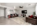 Spacious living room featuring tile floors, comfortable seating, and a ceiling fan at 11473 W Austin Thomas Dr, Surprise, AZ 85378