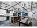 Modern kitchen flows into living space with large island, and stainless steel appliances at 11530 E Vine Ave, Mesa, AZ 85208