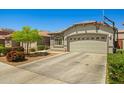 Charming single-story home with a two-car garage and basketball hoop at 12416 W Midway Ave, Glendale, AZ 85307