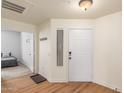 Bright foyer with wood-look floors leads to a bedroom and into the main living space at 15252 N 100Th St # 1156, Scottsdale, AZ 85260