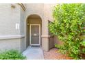 Inviting front entryway with security door and lush desert landscaping at 15252 N 100Th St # 1156, Scottsdale, AZ 85260