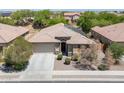 Charming single-story home featuring desert landscaping, covered entry, and a two-car garage at 15704 W Taylor St, Goodyear, AZ 85338