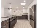 Modern kitchen featuring stainless steel appliances, waterfall countertops, white cabinets, and a gourmet gas cooktop at 1644 W Thunderbird Rd, Phoenix, AZ 85023