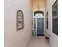 Inviting front entryway featuring textured walls and a decorative iron art piece at 17611 W Ingleside Dr, Surprise, AZ 85374