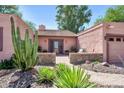 Inviting front entrance with lush desert landscaping and a cozy seating area at 17705 E Canyon Way, Gilbert, AZ 85298