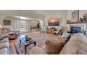 Cozy living room featuring a fireplace, comfortable seating, and lots of natural light at 17705 E Canyon Way, Gilbert, AZ 85298