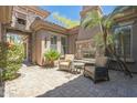 Cozy outdoor patio with a fireplace, comfortable seating, and a lush garden at 1805 W Dusty Wren Dr, Phoenix, AZ 85085