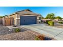 Charming single-Gathering home featuring a two-car garage, desert landscaping, and a well-maintained front yard at 2070 E Saddlebrook Ct, Gilbert, AZ 85298