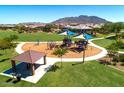 Aerial view of a community playground featuring shaded play structures and grassy areas at 2070 E Saddlebrook Ct, Gilbert, AZ 85298