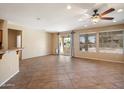 Open-concept living room with tile flooring, sliding glass doors, and lots of natural light at 20900 N Vista Trl, Surprise, AZ 85387