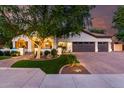 Charming home featuring a brick driveway, lush lawn, and mature tree shading the facade at 2139 S Granite St, Gilbert, AZ 85295
