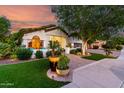 Inviting home exterior with manicured lawn, potted plants, and cozy front patio seating at 2139 S Granite St, Gilbert, AZ 85295