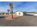 Well-maintained home with a carport, beautiful yard featuring decorative rock, and mature landscaping at 22312 W Hammond Dr, Buckeye, AZ 85326