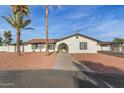 Charming single-story home with white stucco and red rock landscaping in a sunny neighborhood at 22312 W Hammond Dr, Buckeye, AZ 85326