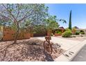 Lovely single-story home featuring a neatly maintained driveway, landscaping, and a vintage wagon wheel decoration at 3131 E Las Rocas Dr, Phoenix, AZ 85028