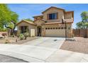 Inviting home featuring desert landscaping, a two-car garage, and a basketball hoop at 32901 N Hidden Canyon Dr, San Tan Valley, AZ 85144