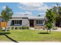 Traditional home with well-maintained lawn, tasteful landscaping and architectural details at 338 W Encanto Blvd, Phoenix, AZ 85003