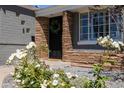 Close-up showcasing a front door with brickwork, a wreath, and decorative landscaping at 338 W Encanto Blvd, Phoenix, AZ 85003