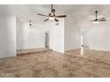 Spacious living room featuring tile flooring, high ceilings, ceiling fans, and neutral paint at 4107 W Campo Bello Dr, Glendale, AZ 85308