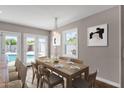 Dining room with modern light fixtures, wood table setting, and view of private swimming pool at 4216 N 20Th St, Phoenix, AZ 85016
