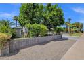 Charming home exterior with lush green trees, side yard, and large driveway at 4216 N 20Th St, Phoenix, AZ 85016