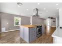 Spacious kitchen island with stainless steel appliances and view into the living room at 4216 N 20Th St, Phoenix, AZ 85016