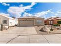 Charming home featuring a tile roof, tan stucco, a 2-car garage, and desert landscaping for low maintenance appeal at 4387 E Hartford Ave, Phoenix, AZ 85032