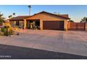 Well-maintained house featuring a two-car garage, desert landscaping, and a spacious driveway at 4901 W Corrine Dr, Glendale, AZ 85304