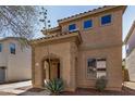 Front exterior view of the home with an arched entryway and desert landscaping at 514 N 112Th Dr, Avondale, AZ 85323