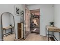 Inviting entryway with wood floors, stylish mirror, and a glimpse of the private patio at 6940 E Cochise Rd # 1027, Paradise Valley, AZ 85253