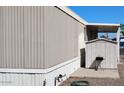 Exterior shot featuring siding, shed, and yard with grill at 730 S Country Club Dr # 81, Mesa, AZ 85210
