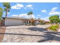 A beautiful single-story home featuring a wide driveway and manicured landscaping at 735 E Northern Ave, Phoenix, AZ 85020