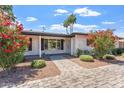 Charming brick home with colorful landscaping, walkway, and vibrant curb appeal at 735 E Northern Ave, Phoenix, AZ 85020