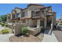 Charming condo building showcasing well-maintained landscaping, with a private patio and balcony space at 839 S Westwood -- # 170, Mesa, AZ 85210