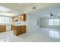Bright living room and kitchen with tile floors, white walls, ceiling fans, and a skylight to fill with light at 839 S Westwood -- # 170, Mesa, AZ 85210