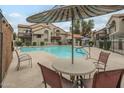 Community pool area with lounge chairs, tables, and shade, surrounded by the complex buildings at 839 S Westwood -- # 170, Mesa, AZ 85210