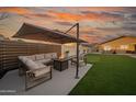 Outdoor patio with comfortable seating, a fire pit, and a putting green offers the perfect entertaining space at 9013 E Shooting Star Dr, Gold Canyon, AZ 85118