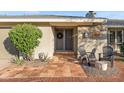 Inviting covered porch with double doors, updated tiles, and decorative outdoor seating at 9221 N Camino Vista Ln, Phoenix, AZ 85028