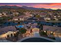 Stunning aerial view of a luxurious home with a lake, pool, and beautifully landscaped yard at 16683 S 180Th Dr, Goodyear, AZ 85338
