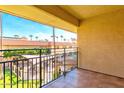 Cozy balcony overlooking a serene courtyard with a pool, seating and lush landscaping at 10330 W Thunderbird Blvd # C304, Sun City, AZ 85351