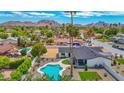 An aerial view displays a large swimming pool and a spacious backyard, offering privacy and a beautiful mountain backdrop at 11039 N 42Nd St, Phoenix, AZ 85028