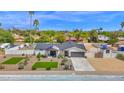 Beautiful home boasts manicured landscaping, a white fence, and a private pool in a desirable location at 11039 N 42Nd St, Phoenix, AZ 85028