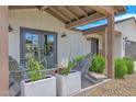 Inviting front porch with cozy seating, stylish decor, and a view of the well-maintained front yard and neighborhood at 11039 N 42Nd St, Phoenix, AZ 85028
