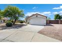 Inviting single-story home featuring desert landscaping and a spacious driveway at 1120 S Valley Dr, Apache Junction, AZ 85120