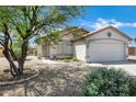 Attractive single-story home showcasing desert landscaping, mature tree, and stucco facade at 1120 S Valley Dr, Apache Junction, AZ 85120