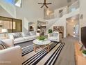 Bright living room with vaulted ceilings and white furniture at 1274 W Dexter Way, San Tan Valley, AZ 85143