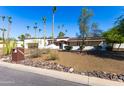 Inviting home featuring a manicured lawn, mature trees, and xeriscaping at 13051 N 70Th St, Scottsdale, AZ 85254