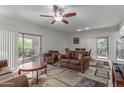 The spacious living room with modern ceiling fan and balcony access at 16801 N 94Th St # 2056, Scottsdale, AZ 85260