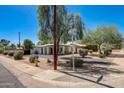 Corner lot home featuring desert landscaping, a well maintained lawn, and a vintage street sign at 1701 W Clarendon Ave, Phoenix, AZ 85015